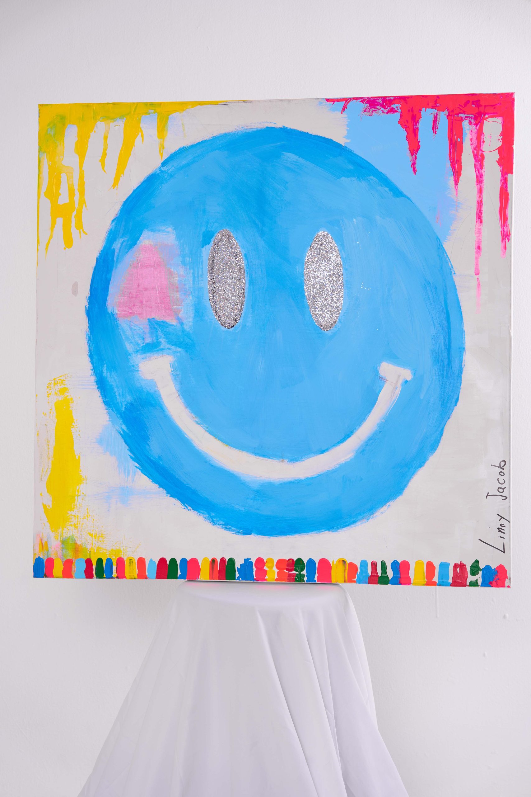 Blue Glitter Smiley painting by Linoy Jacob with silver glitter eyes and colorful drips
