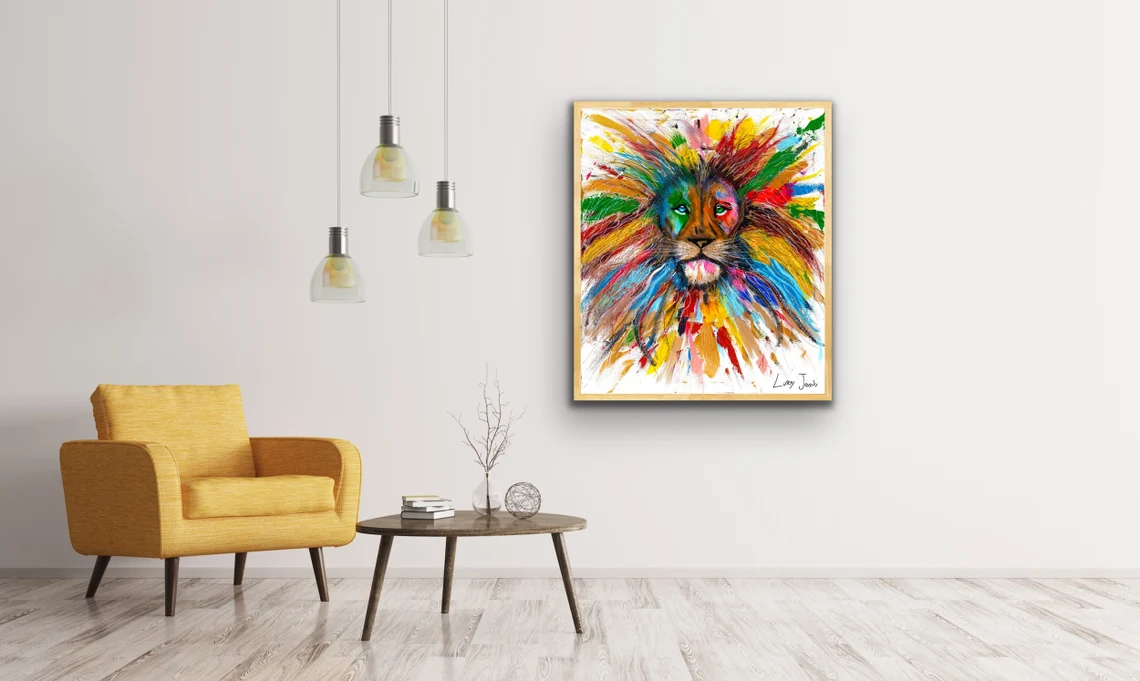 Colorful lion painting by Linoy Jacob displayed in a modern interior with a yellow armchair and minimalist décor.